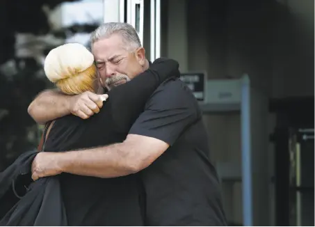  ?? Photos by Paul Chinn / The Chronicle ?? Autumn Ayres and Doug Tollis, volunteers who regularly searched for Sierra LaMar, hug in relief after the jury’s guilty verdict.