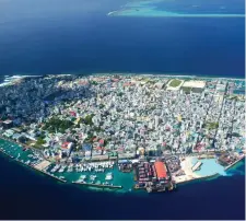  ??  ?? Top: Andrew Roddy with his wife Gill Campion on their wedding day. Left: the couple. Above: Malé, the capital of the Maldives