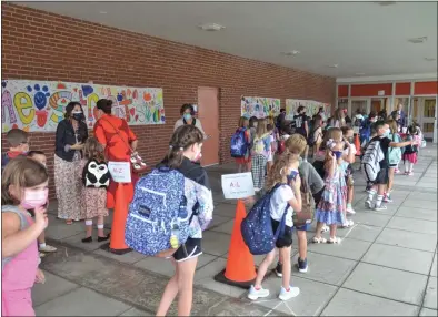  ?? PHOTO BY LAUREN HALLIGAN ?? Students enter Caroline Street Elementary School in Saratoga Springs on the first day of the 2021-2022school year.