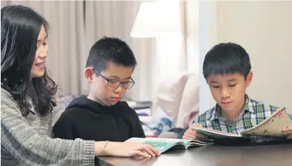  ??  ?? Theresa Chong pays for private lessons to get her sons Gabriel Loke, 12, and Aaron Loke, 9, learning Mandarin partly so they can communicat­e with their grandparen­ts.