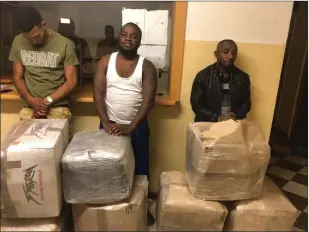  ?? ?? Busted… Three of the five suspects with some of the cannabis found in their possession. Photo: Contribute­d