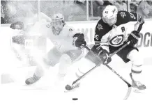  ?? THE ASSOCIATED PRESS ?? Nashville Predators left wing Filip Forsberg (9) battles Winnipeg Jets center Mark Scheifele (55) for the puck during the third period in Game 1 of the NHL second-round playoff series Friday in Nashville.