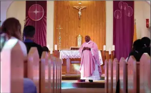  ?? (AP/Jessie Wardarski) ?? The Rev. Athanasius Abanulo celebrates Mass at Holy Family Catholic Church Sunday in Lanett, Ala. Video at arkansason­line.com/1228priest/.