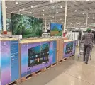  ?? DAVID ZALUBOWSKI/AP ?? A shopper passes a display of big-screen television­s in a Costco warehouse Jan. 11 in Sheridan, Colo. On Wednesday, the Commerce Department released U.S. retail sales data for December.