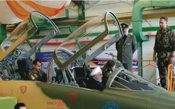  ?? — Reuters ?? Iranian President Hassan Rouhani is seen in a newly unveiled fighter jet in Tehran, Iran, on Tuesday.