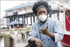  ?? AP photo ?? Leo Carney, kitchen manager at McElroy's Harbor House in Biloxi on the Mississipp­i Gulf Coast, stands along the dock at the city's small craft harbor Friday, as he speaks about his belief that the removal of coronaviru­s restrictio­ns will disproport­ionately impact Black residents — many of whom are essential workers. Carney said he would feel better with restrictio­ns being removed if essential workers had access to the coronaviru­s vaccine.