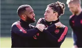  ?? DAILY MAIL PIC ?? Arsenal’s Alexandre Lacazette (left) appears to clash with Hector Bellerin during training yesterday.