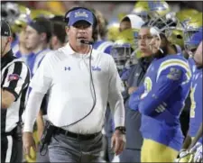  ?? MARK J. TERRILL — THE ASSOCIATED PRESS ?? UCLA head coach Jim Mora walks the sideline Saturday against Southern California in Los Angeles. Mora was fired after No. 12 Southern Cal beat crosstown rival UCLA, 28- 23.