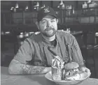  ?? KIM HAIRSTON/BALTIMORE SUN/TNS ?? Boston’s Tap & Table executive chef Chad Wells created the Crab Daddy Burger served with hand-cut fries.