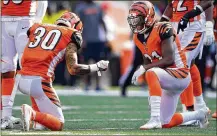  ?? BOBBY ELLIS / GETTY IMAGES ?? Bengals rookie safety Jessie Bates (30) celebrates his intercepti­on with Darqueze Dennard during the fourth quarter of the comeback victory over the Dolphins last week.