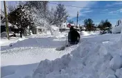  ?? AP ?? Martin Haslinger uses a snowblower outside his home in Buffalo, N.Y., followinga lake-effect snowstorm.