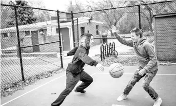  ??  ?? Zeitler, 18, left, and his friend Afonsky, 17, play basketball near their home in Washington, D.C.