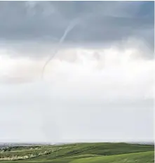  ??  ?? Ominous skies over the Cabot Links Golf Course last Friday prompted Margy Krause to look up. That’s when she spotted this waterspout. If you look closely, you can see the spray vortex on the water.