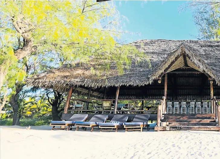  ?? Pictures: Ananta ?? SOME SHACK The 200m² island of Quissanga, neighbouri­ng Medjumbe, boasts the shelter of Robinson Crusoe’s dreams — with a bar and a four-poster bed. Below is an aerial shot of Medjumbe.