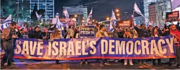  ?? (AFP) ?? Israelis march during a rally against controvers­ial government plans to give lawmakers more control of the judicial system in Tel Aviv on Saturday