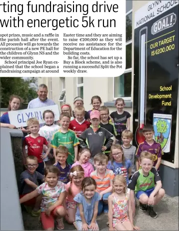  ??  ?? Glynn NS principal Joe Ryan with pupils who are fundraisin­g for the new PE Hall.