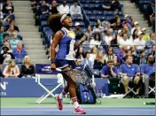  ?? ASSOCIATED PRESS PHOTOS ?? ABOVE: NAOMI OSAKA, OF JAPAN, REACTS AFTER SCORING A POINT against Angelique Kerber, of Germany, during the first round of the U.S. Open on Tuesday in New York. RIGHT: Kerber returns a shot from Osaka during the first round.