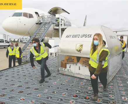  ?? MICHAEL CLEVENGER / POOL VIA REUTERS ?? A shipment of the COVID-19 vaccine is loaded on a ramp at Louisville Muhammad Ali Internatio­nal Airport in Louisville, Ky., on Sunday.