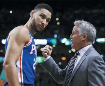  ?? CHARLES KRUPA — THE ASSOCIATED PRESS ?? 76ers coach Brett Brown, right, talks with guard Ben Simmons before Game 5 Wednesday night against the Celtics in Boston. Once again, inconsiste­nt 3-point shooting played a role as Boston won, 114-112, to eliminate the 76ers in the Eastern Conference...