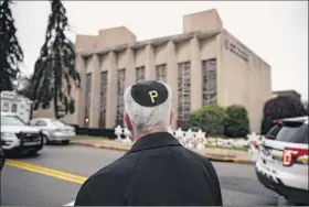  ??  ?? Matt Rourke / Associated Press Rabbi Jeffrey Myers of the Tree of Life / Or L’simcha Congregati­on stands near the Tree of Life synagogue and wears a yarmulke with a Pittsburgh Pirates logo in Pittsburgh on Monday.