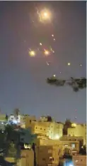  ?? Reuters ?? Right: Objects are seen in the sky over Amman after Iran launched drones towards Israel.