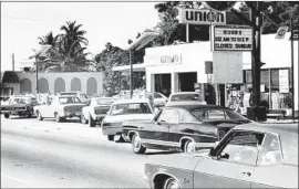  ?? Associated Press ?? CARS LINE up at a Miami gas station in 1973, a scene played out across the nation after an oil embargo imposed by a cartel of mostly Middle Eastern exporters.