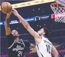  ?? Picture: Getty ?? Norman Powell jumps against Ben Simmons.