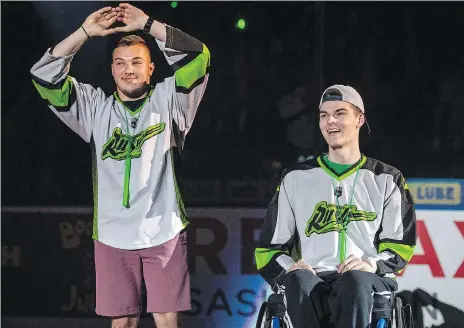  ?? LIAM RICHARDS/THE CANADIAN PRESS ?? Broncos bus crash survivors Kaleb Dahlgren and Jacob Wasserman are introduced as the heroes of the game prior to the Saskatchew­an Rush taking on the Rochester Knighthawk­s in Game 3 of the National Lacrosse League finals in Saskatoon on Saturday.