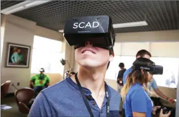  ?? CINDY ORD/GETTY IMAGES FOR SCAD/AFP ?? Guests sample the VR experience­s on display at the 19th Annual Savannah Film Festival presented by SCAD in Savannah, Georgia. VR cinemas are expected to open in Beijing, Shanghai and Los Angeles in the next few weeks.