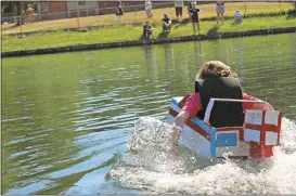  ?? Blake Doss / Rome News-Tribune ?? Griffin Girard, 12, races in his cardboard boat, the S.S. Boaty McBoat Face, on Saturday.