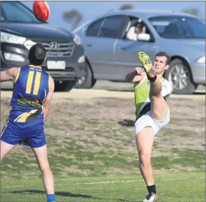  ??  ?? TOP SNAP: Jeparitrai­nbow’s Peter Weir screws a ball around the corner to score a goal for the Storm at Natimuk. Picture: PAUL CARRACHER