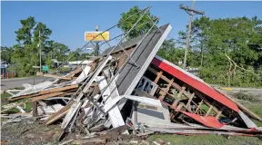  ?? LESLIE WESTBROOK/THE TIMES-PICAYUNE/THE NEW ORLEANS ADVOCATE VIA AP ?? On Tuesday, the wreckage of a decorative lighthouse destroyed in a storm Monday night is seen in Henderson, La.