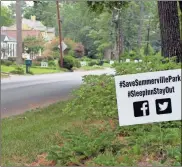  ?? Doug Walker ?? Signs opposing a Sleep Inn at Charlton Street and U.S. 27 North are up in the majority of yards throughout the Summervill­e Park community.