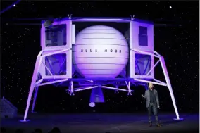  ?? PATRICK SEMANSKY ?? FILE - In this, May 9, 2019, file photo, Jeff Bezos speaks in front of a model of Blue Origin’s Blue Moon lunar lander in Washington. Bezos and Virgin Galactic’s Richard Branson favor going back to the moon before Mars. SpaceX’s Elon Musk also is rooting for the moon, although his heart’s on Mars.