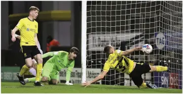  ??  ?? Tom Hamer makes a despairing effort to clear off the line but it proved in vain as Curtis Main gave Shrewsbury Town an early lead at the Pirelli Stadium.