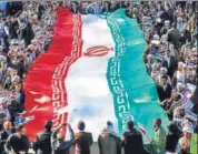  ?? AFP ?? Progovernm­ent demonstrat­ors wave Iranian flag in Qom