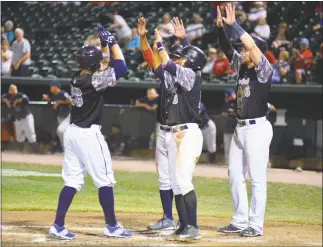  ?? PHOTO BY BERT HINDMAN ?? Zach Wilson celebrates with teammates after hitting a grand slam in the bottom of the fifth of Tuesday’s 8-5 Blue Crabs win over Somerset at Regency Furniture Stadium in Waldorf. Wilson also hit a solo shot in the second inning.