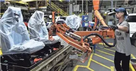  ??  ?? A worker assembles trucks in Louisville. As robots take over more jobs, millions of workers will need to be trained for new occupation­s. TIMOTHY D. EASLEY/AP