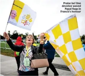  ??  ?? Praise be! One devotee waved Papal flags in Francis’s honour