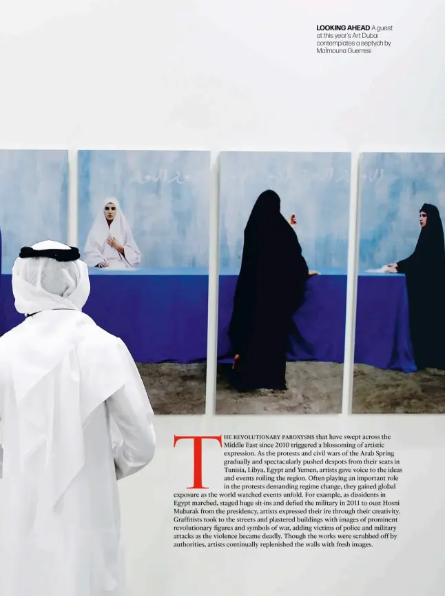  ??  ?? looking ahead A guest at this year’s Art Dubai contemplat­es a septych by Maïmouna Guerresi