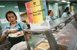 ?? WONG MAYE-E/AP ?? Cafeteria staff serve vegetarian and vegan options to seventh graders during their lunch break at a public school Friday in the Brooklyn borough of New York.
