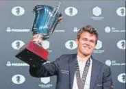  ?? AFP ?? Magnus Carlsen with his world championsh­ip trophy.