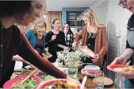  ?? KATHERINE FREY WASHINGTON POST ?? A dozen women gather together at a recent gathering of the Dinner Party, a community of young adults who have experience­d significan­t loss.