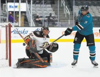  ?? Tony Avelar / Associated Press ?? Anaheim goaltender Anthony Stolarz blocks a shot by Sharks left wing Evander Kane during the first period. The Sharks had a busy day of trading — then got shut out.