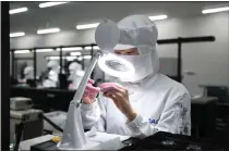  ?? NIROKO HAYASHI — THE NEW YORK TIMES ?? A Casio worker inspects an automatic timepiece movement at the Yamagata Casio factory. The factory employs about 600people.