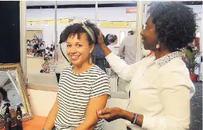  ??  ?? This patron seems happy with the result of the Wassi Curls solution being applied to her hair.