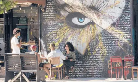  ?? DAMIAN DOVARGANES/AP ?? Diners enjoy themselves June 5 at a soul food restaurant in Los Angeles. The delta variant is causing worry even in vaccinated countries.