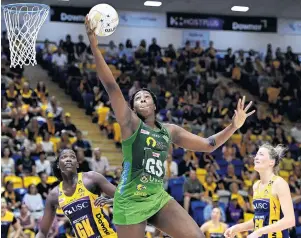  ?? PHOTO: GETTY IMAGES ?? Big reach . . . West Coast Fever goal shooter Jhaniele Fowler hauls the ball in as Sunshine Coast Lightning defenders Phumza Maweni and Karla Pretorious watch during their semifinal on the Sunshine Coast on Sunday.