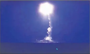  ?? AP Photo ?? A Russian navy ship launches a cruise missile in the Caspian Sea in this photo made from the footage taken from Russian Defense Ministry’s official website. Russia’s Defense Minister Sergei Shoigu said four Russian navy ships in the Caspian launched 26...