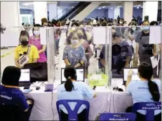  ?? Photo: Pattarapon­g Chatpattar­asill ?? People queue for their COVID-19 vaccine booster shot at a shopping mall in Pathum Thani province on Dec 24.